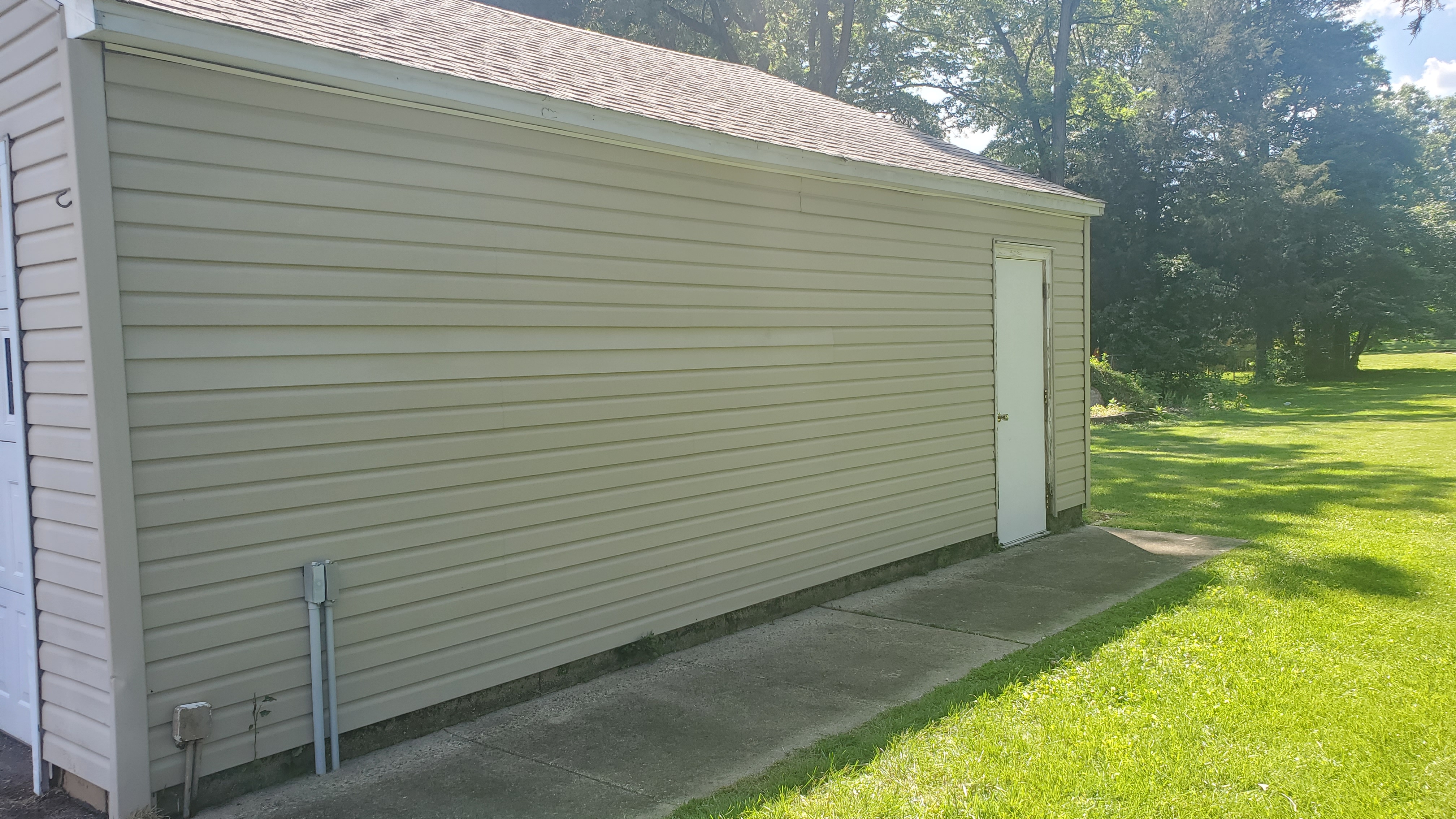 Garage exterior siding clean and bright white after professional soft wash