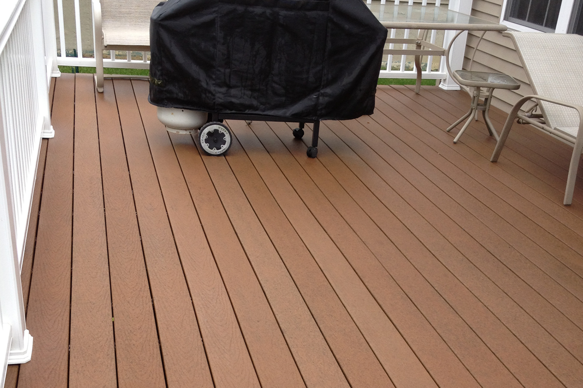 Composite Trex deck restored to warm cedar color after professional soft wash cleaning