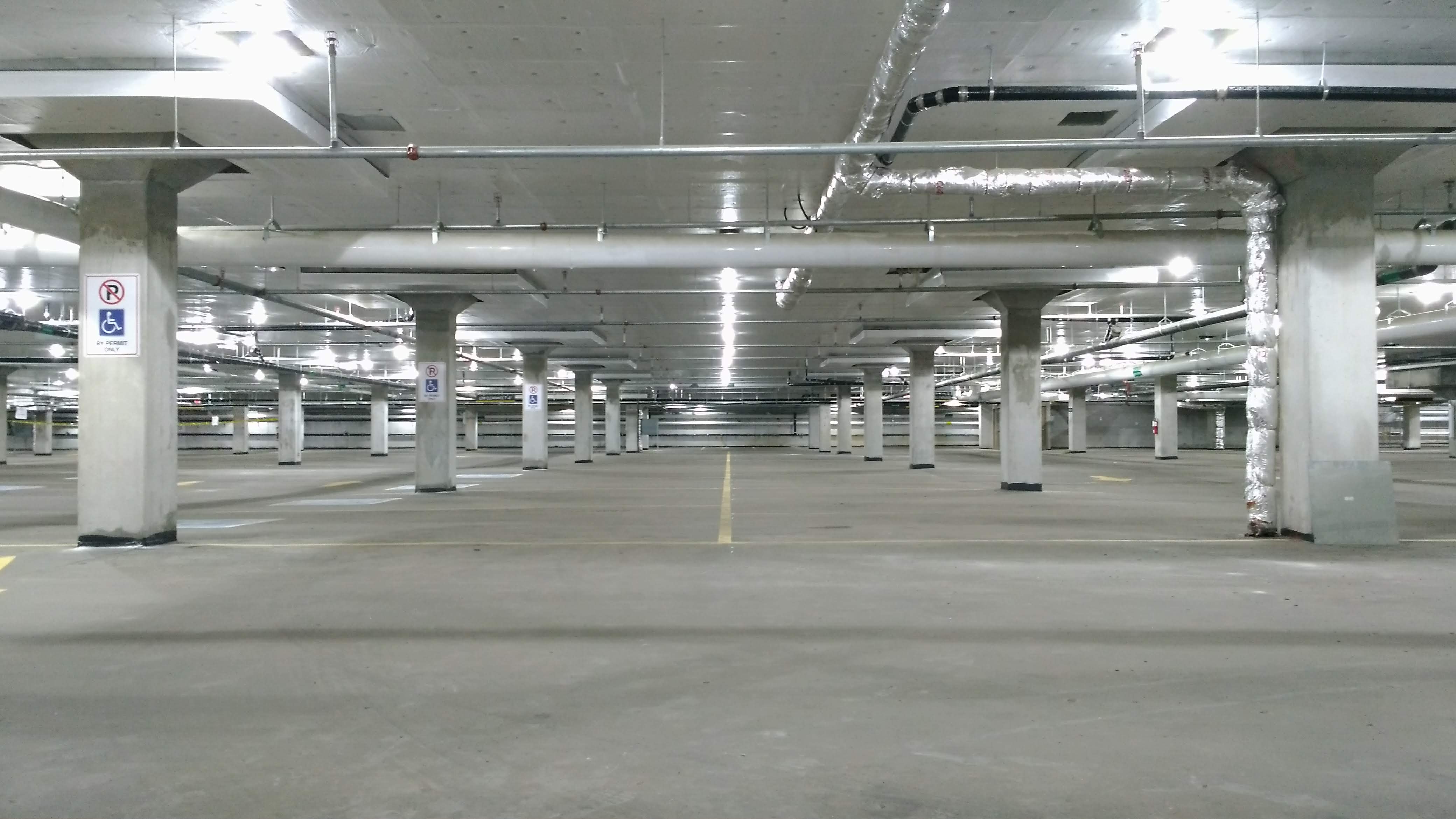 Large empty parking garage with concrete floors and columns