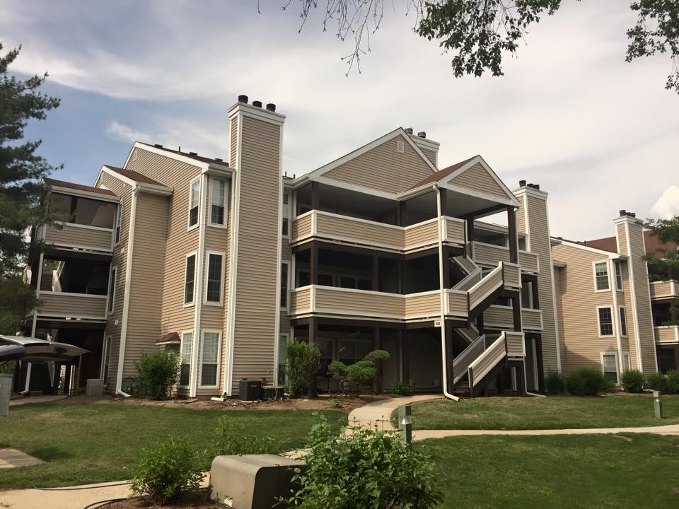 Multi-story apartment complex exterior showing siding and balconies